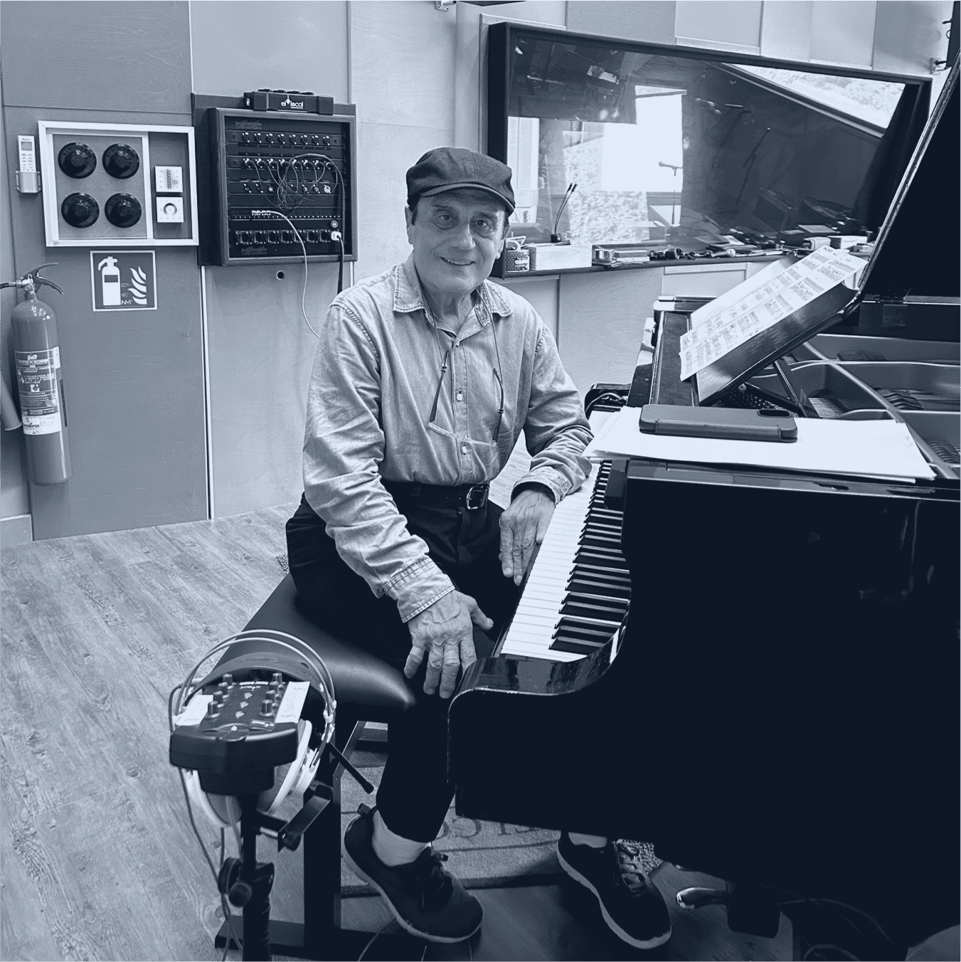Luis Pardellans in a studio next to a piano